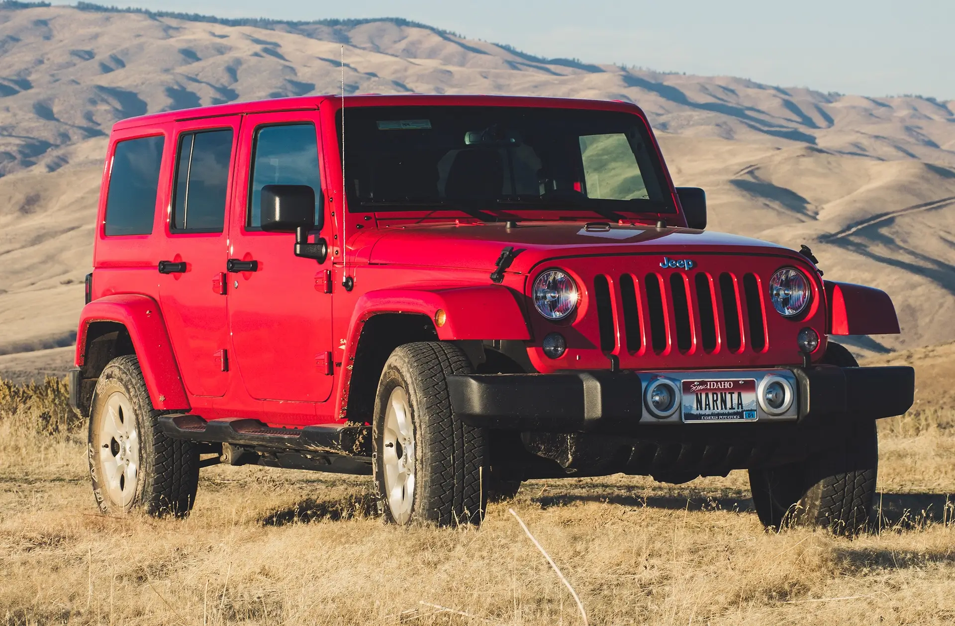 Red Jeep on desert field showing off a lift kit