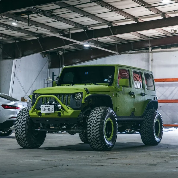 Collision repair, green jeep, g wagon, in a mechanic shop